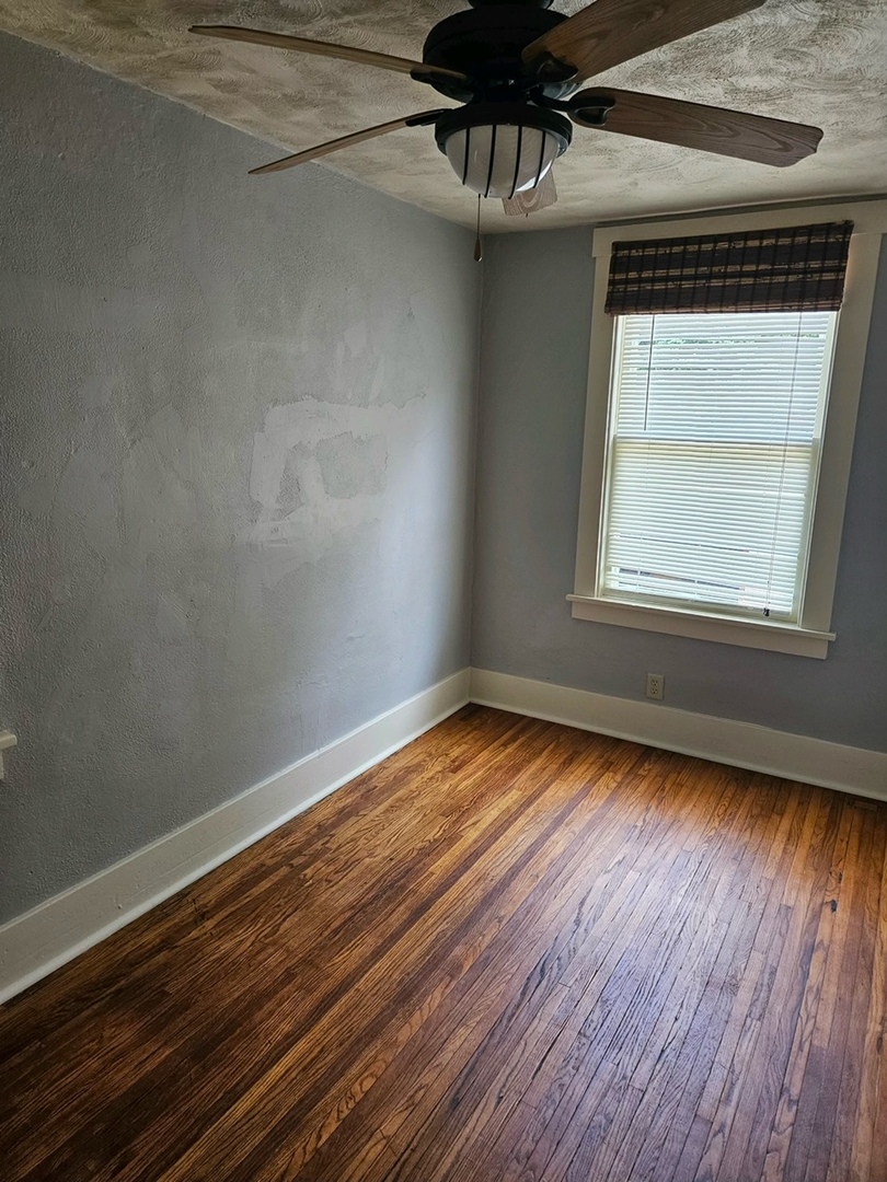 416 Madison Avenue Dixon, IL 61021 - Photo 10 of 34 a view of an empty room with wooden floor and a window