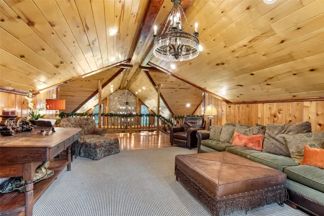 a outdoor space with lots of white furniture and a chandelier