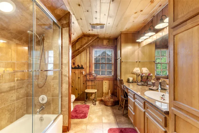 a bathroom with a bathtub shower sink mirror and vanity