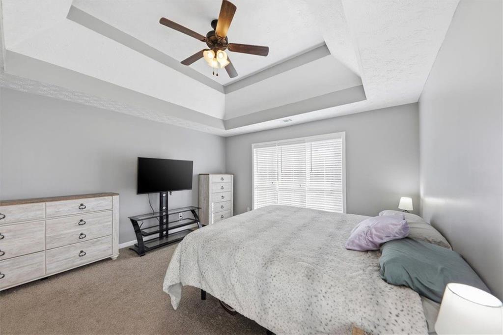493 Youth Jersey Road Covington, GA 30014 - Photo 28 of 52 a bedroom with a bed tv and a window