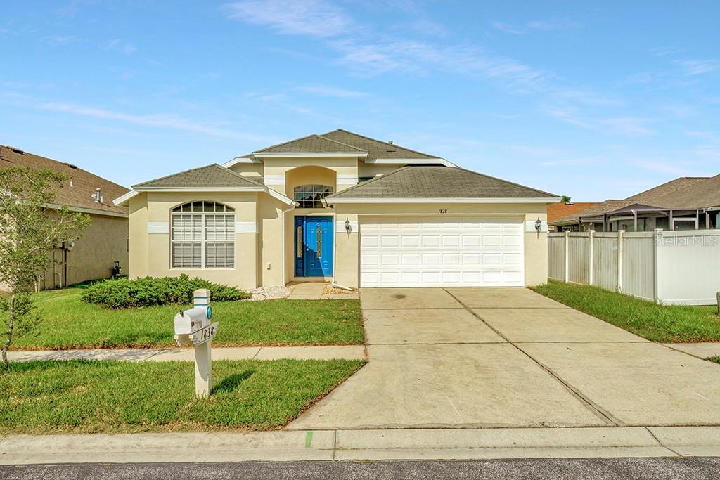 1838 Leybourne Loop Wesley Chapel, FL 33543 - Photo 1 of 1 a front view of a house with a yard
