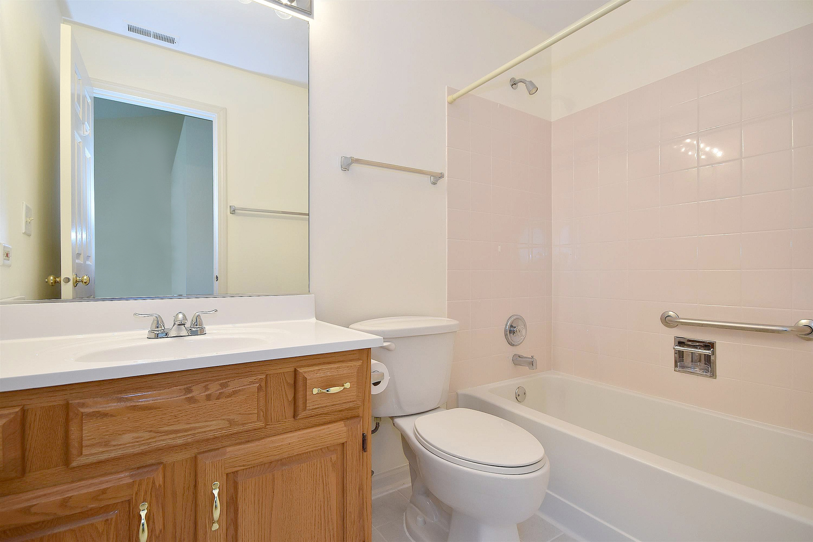 8279 Ripple Ridge, Unit 8279 Darien, IL 60561 - Photo 14 of 28 a bathroom with a sink a toilet and a mirror