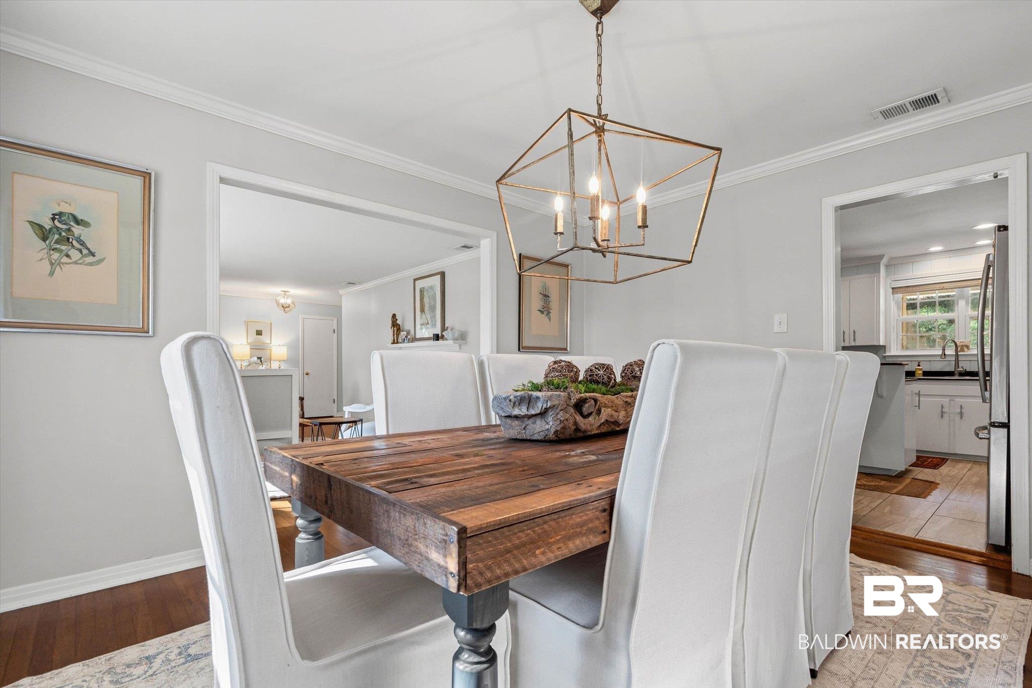 313 Brawood Drive Mobile, AL 36608 - Photo 6 of 32 Dining area featuring crown molding, wood finished floors, and a chandelier