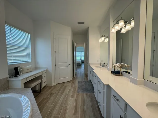 a bathroom with a double vanity sink and a mirror