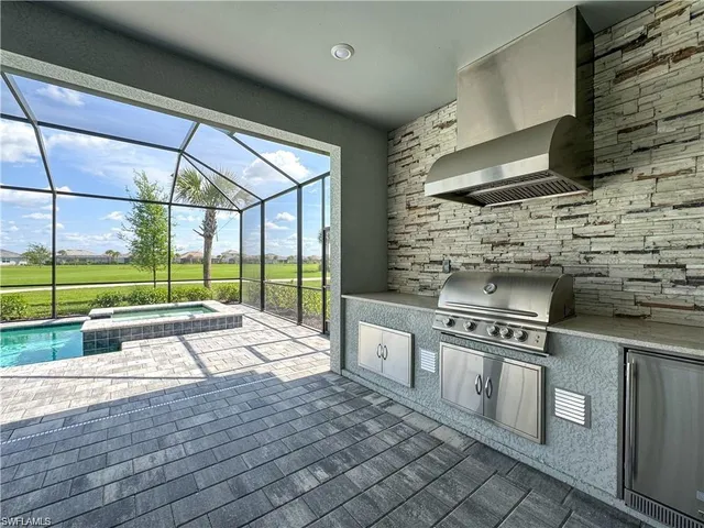 a kitchen with stainless steel appliances wooden floor sink and wooden cabinets