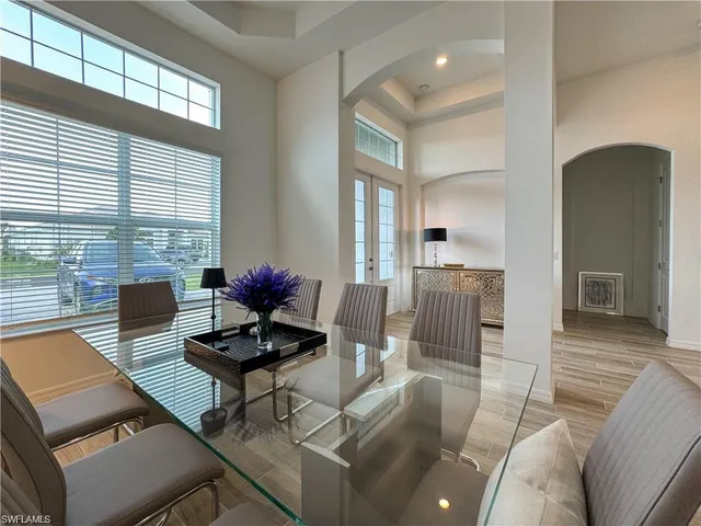 a living room with furniture and floor to ceiling windows