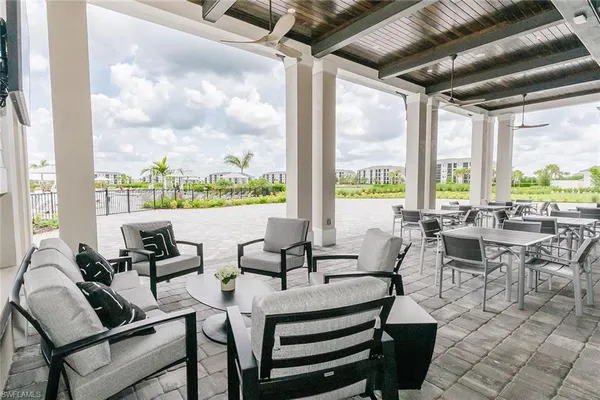 a living room with patio furniture and a floor to ceiling window