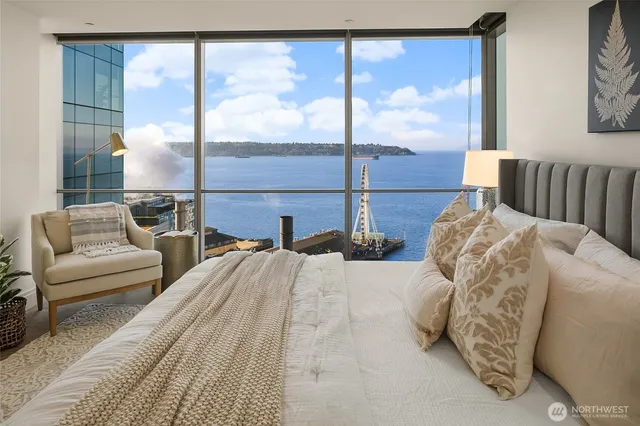 a bedroom with a large bed and a large window