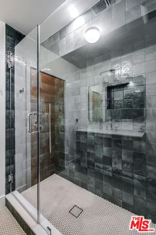 a bathroom with a shower and a sink