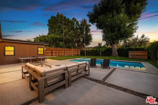 a backyard view with a sitting space