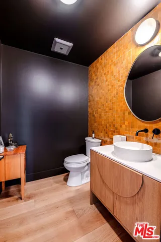 a bathroom with a sink mirror vanity and toilet