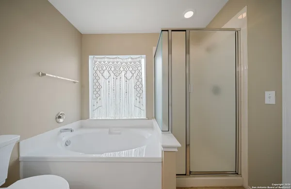 a bathroom with a tub and shower