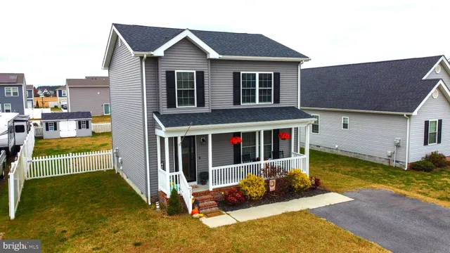 a view of a house with backyard porch and wooden fence