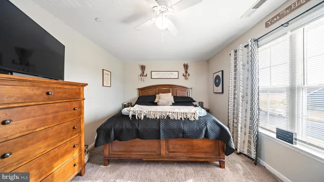 a bedroom with a bed and a flat tv screen