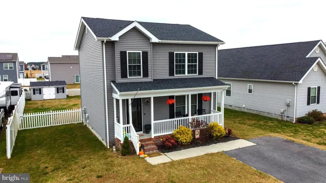 a view of a house with a yard and porch