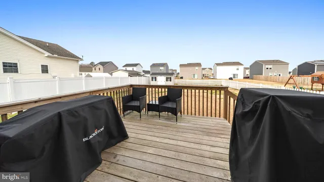 a terrace of a house with wooden floor outdoor seating