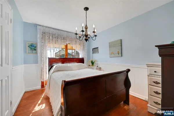 a bed room with a bed mirror and a desk