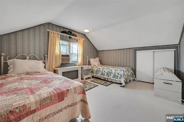 a bedroom with two beds and a window