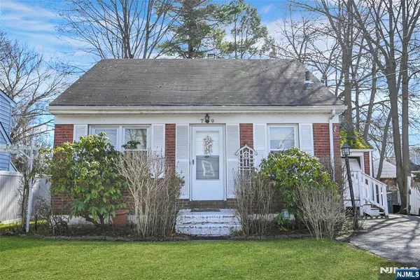 a front view of house with a garden