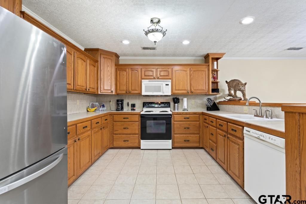 448 North Hill Road Tyler, TX 75706 - Photo 6 of 30 a kitchen with stainless steel appliances granite countertop a stove sink and cabinets