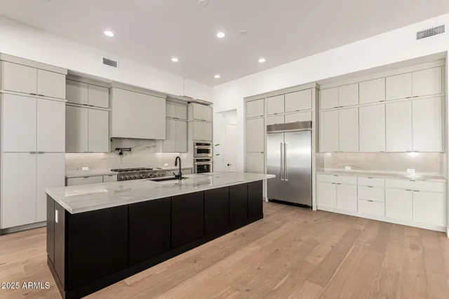 a large kitchen with stainless steel appliances lots of counter space sink and cabinets