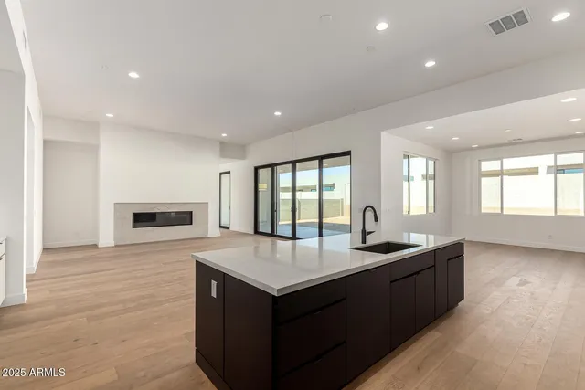 a kitchen with granite countertop sink and cabinets