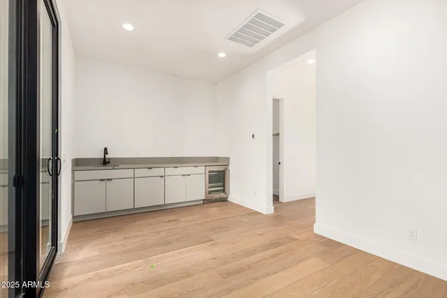 a view of a kitchen with a sink and a refrigerator
