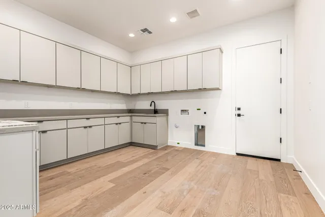 a large white kitchen with white cabinets