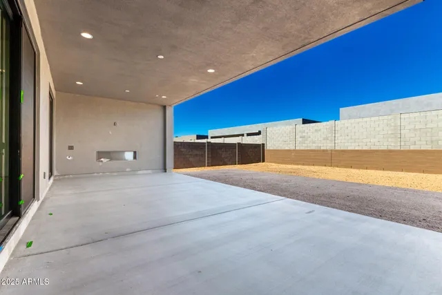 a view of room with a refrigerator and mirror