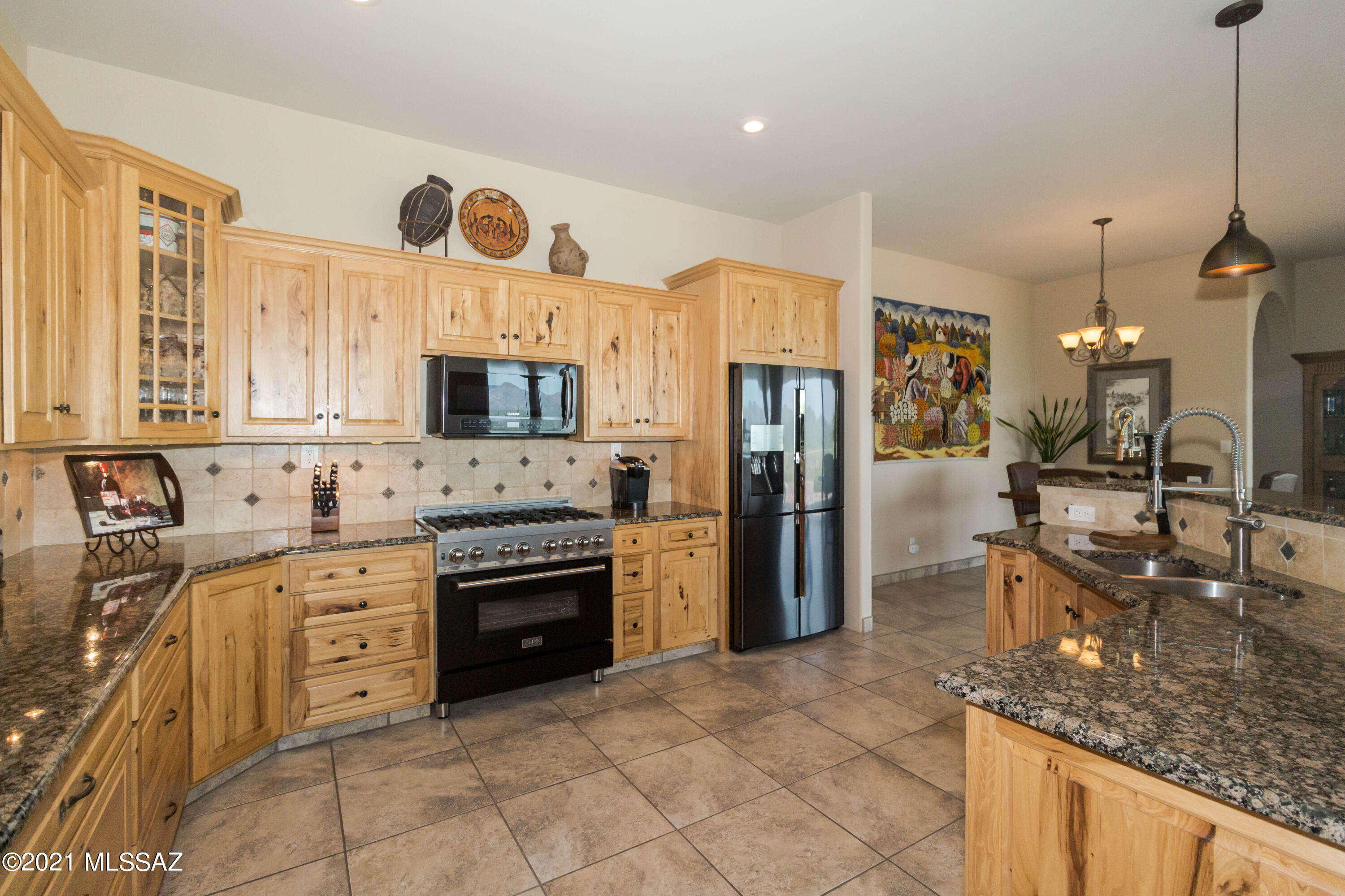 1567 Camino Esturion Rio Rico, AZ 85648 - Photo 22 of 41 a kitchen with stainless steel appliances granite countertop a stove a sink and a refrigerator