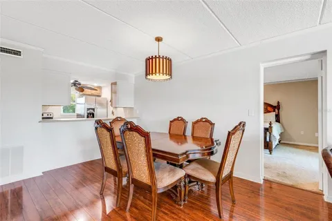 a dining room with furniture and wooden floor