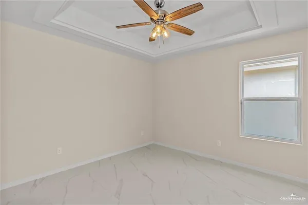 an empty room with a window and a fan