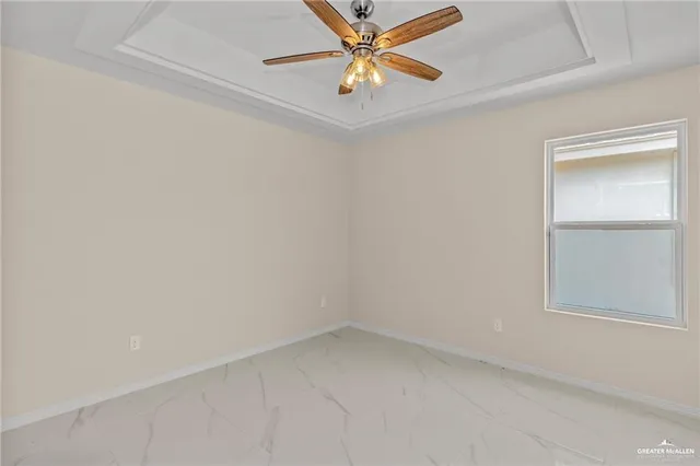 an empty room with a window and a fan