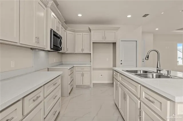 a kitchen with stainless steel appliances granite countertop a sink and cabinets