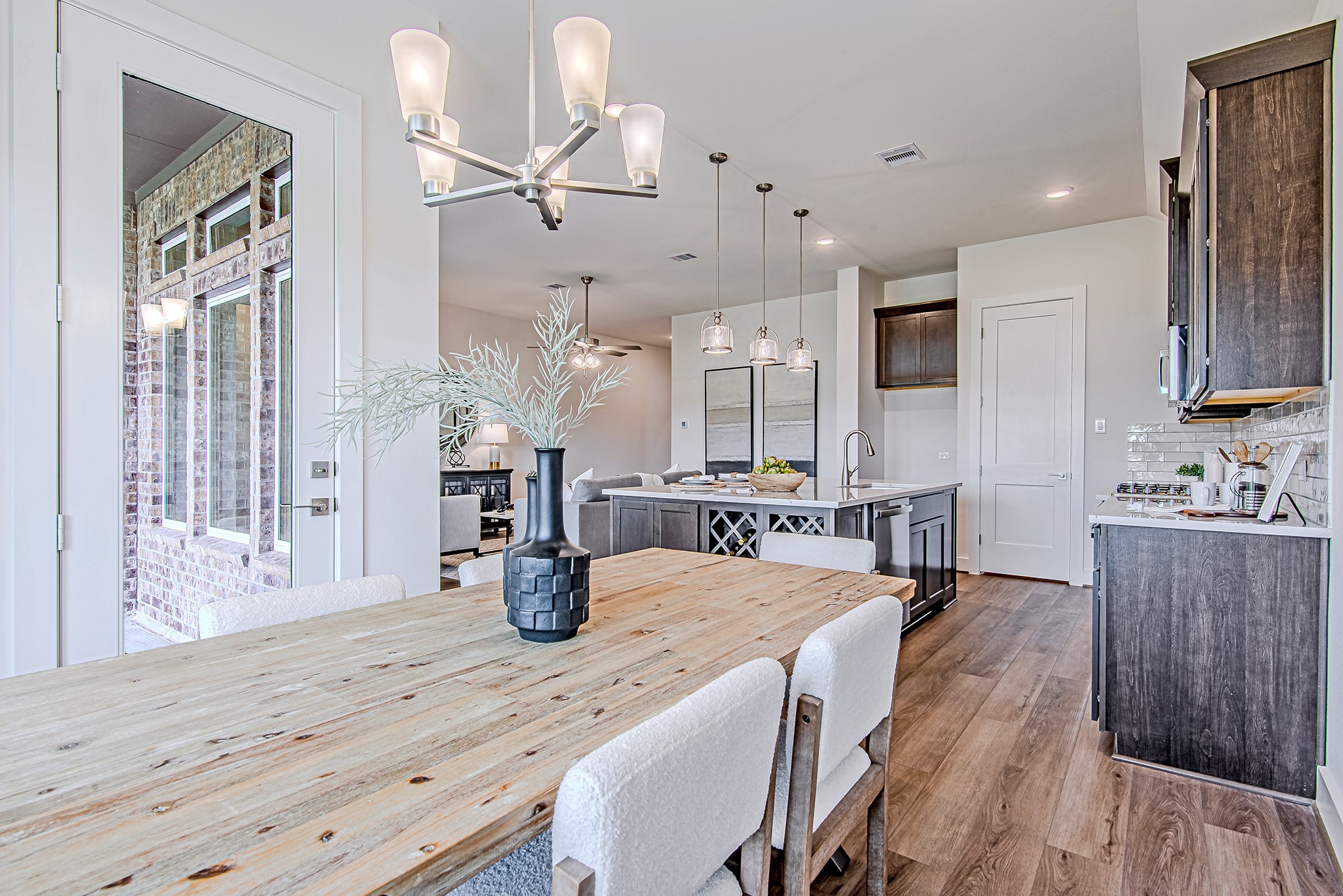 187 Peninsula Point Drive Montgomery, TX 77356 - Photo 11 of 31 From the dining area, enjoy a seamless view into the heart of the home—featuring a stylish kitchen, pendant lighting, and open living space designed for modern living and effortless entertaining.