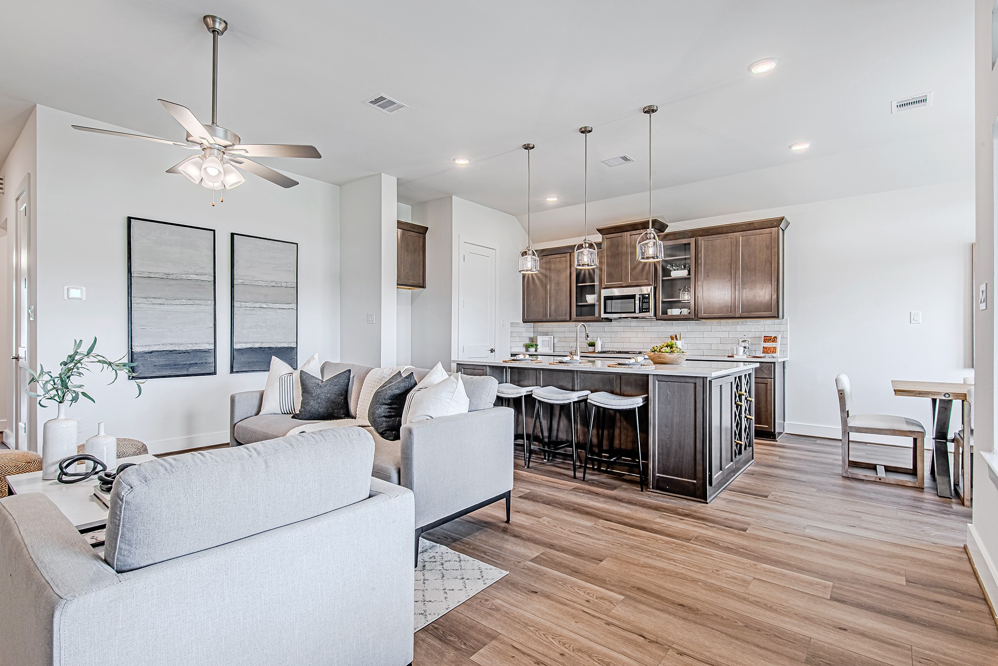 187 Peninsula Point Drive Montgomery, TX 77356 - Photo 12 of 31 This spacious living room offers a clear sightline into the gourmet kitchen and cozy dining nook, creating an airy, connected feel that's perfect for everyday comfort and hosting alike.