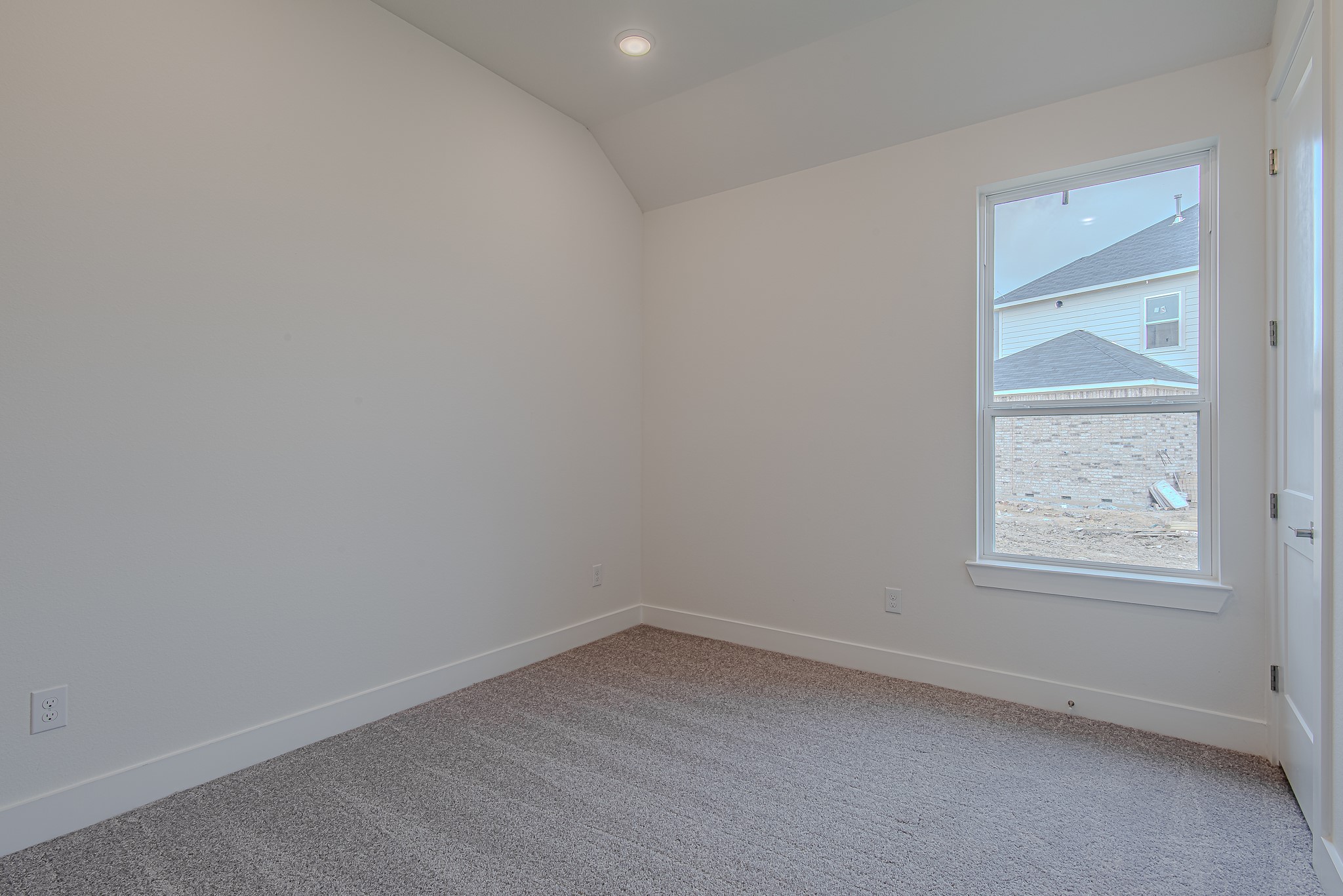187 Peninsula Point Drive Montgomery, TX 77356 - Photo 18 of 31 Secondary bedroom with plush carpet, high ceilings, and a large window—ideal for guests, kids, or bonus space.