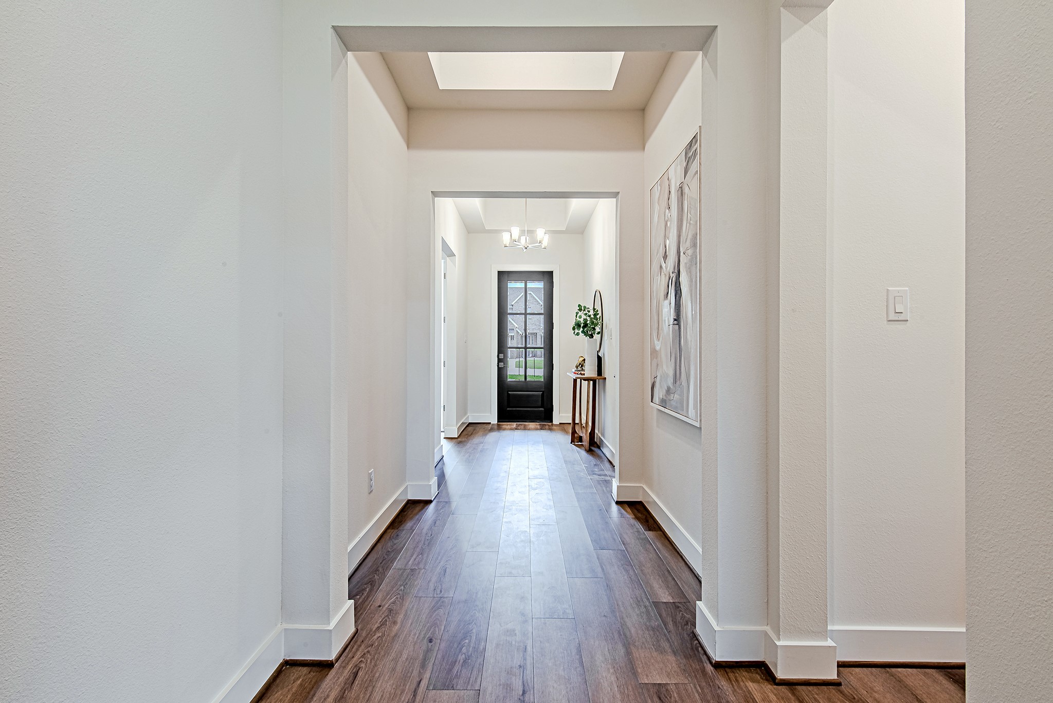 187 Peninsula Point Drive Montgomery, TX 77356 - Photo 6 of 31 Step inside and be greeted by a wide, light-filled foyer that sets a sophisticated tone from the very first step. Crisp lines, clean walls, and elevated ceilings make a stylish first impression.