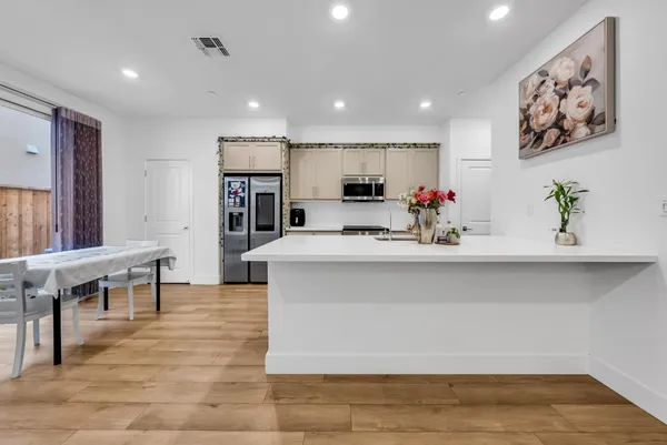 a view of living room with furniture and kitchen view