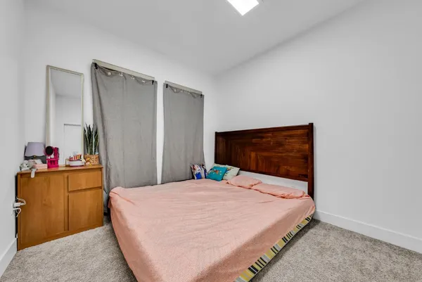 a bedroom with a bed and a dresser