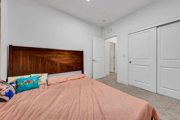 a bedroom with a bed and a dresser