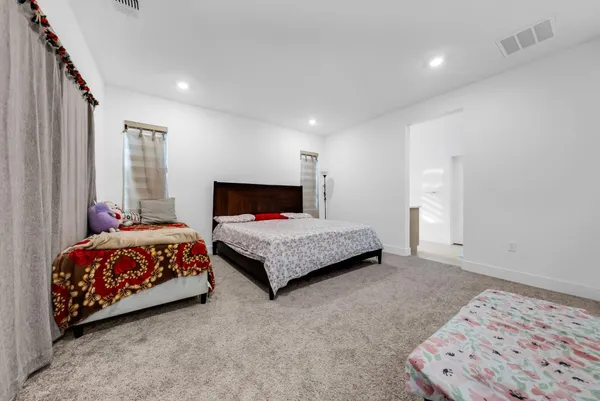 a bedroom with a large bed and a couch