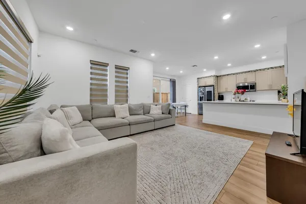 a living room with furniture and kitchen view