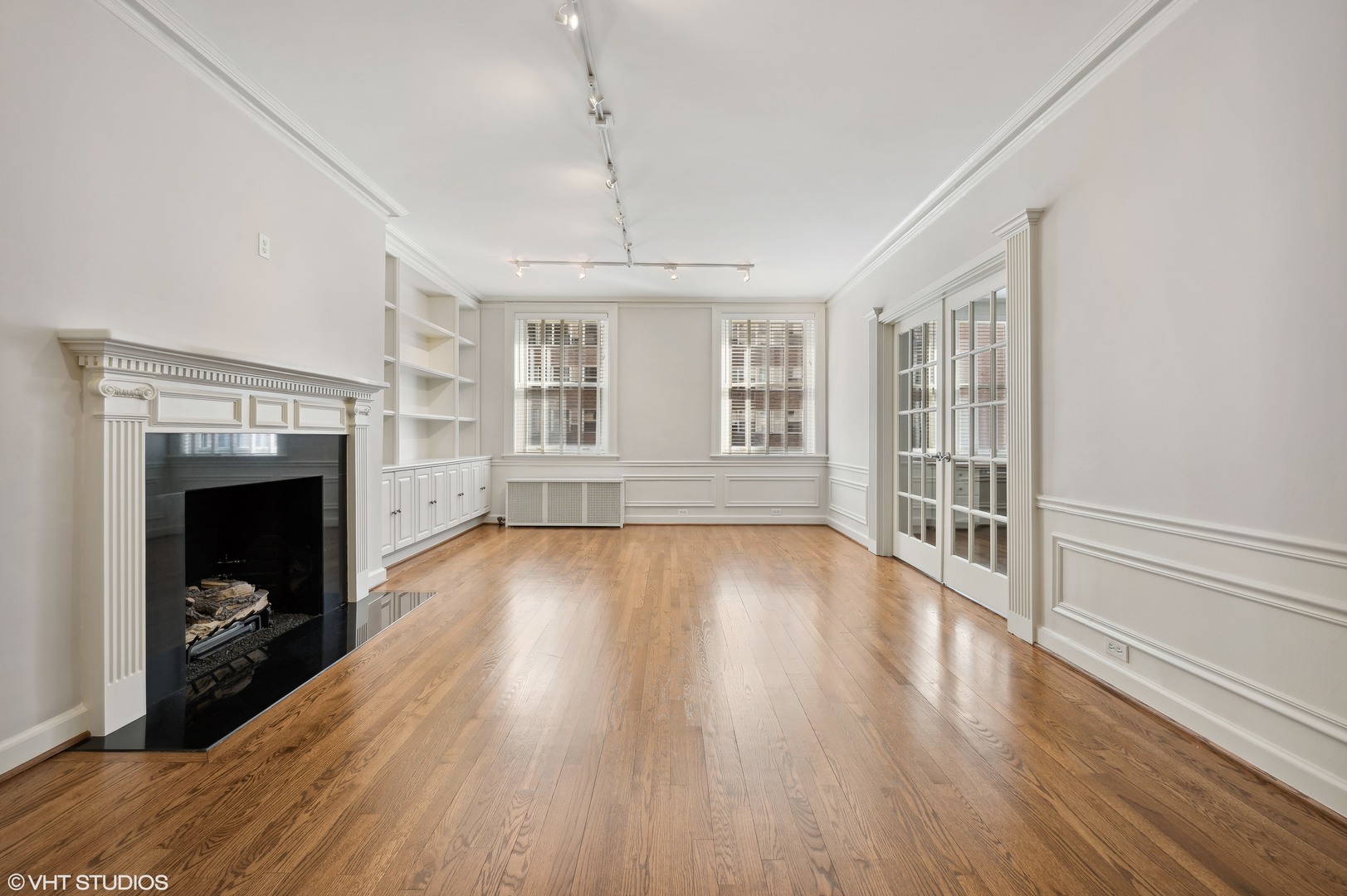 3100 North Sheridan Road, Unit 4D Chicago, IL 60657 - Photo 6 of 21 an empty room with wooden floor fireplace and windows
