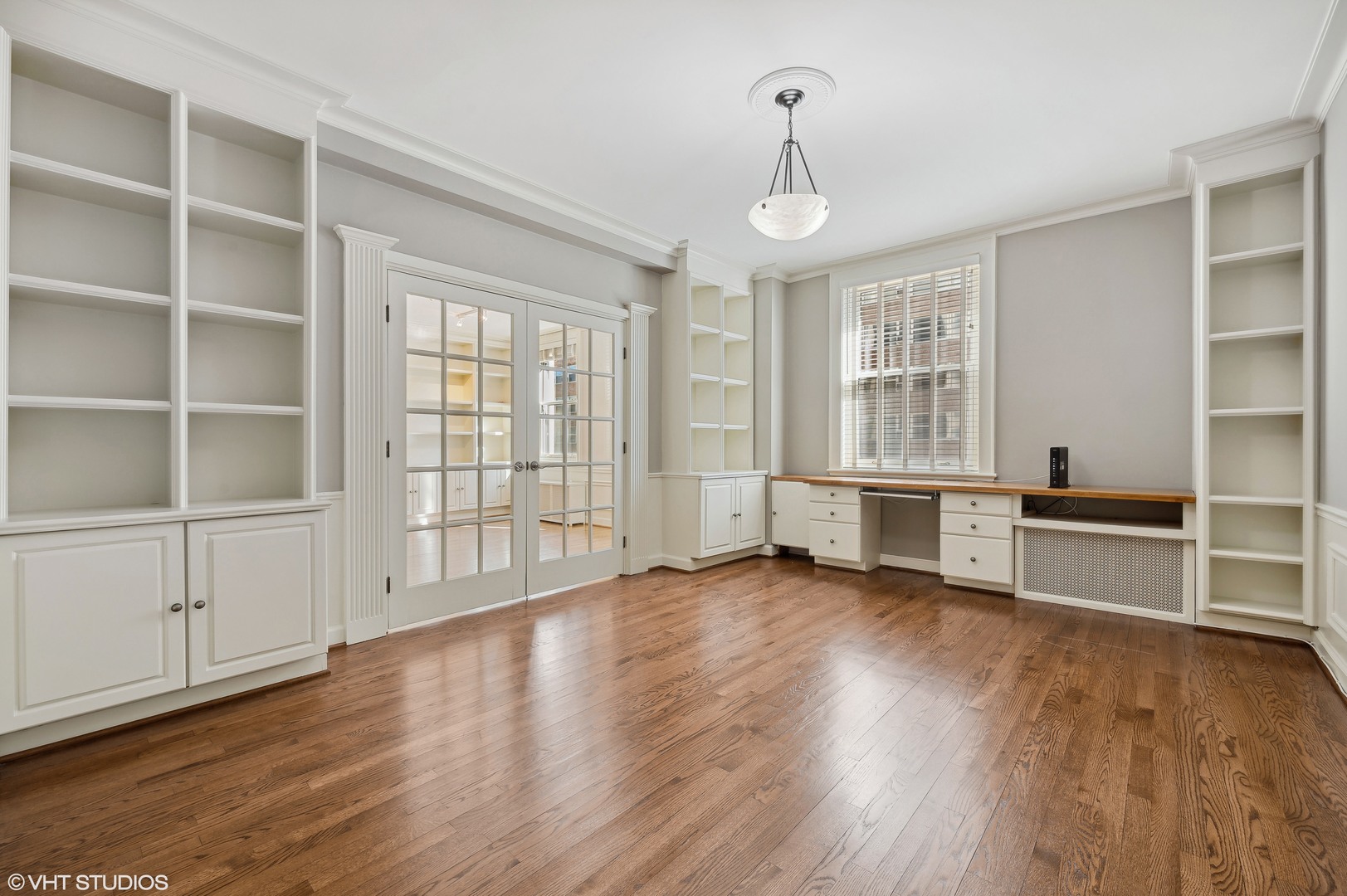 3100 North Sheridan Road, Unit 4D Chicago, IL 60657 - Photo 9 of 21 a view of an empty room with a window and wooden floor