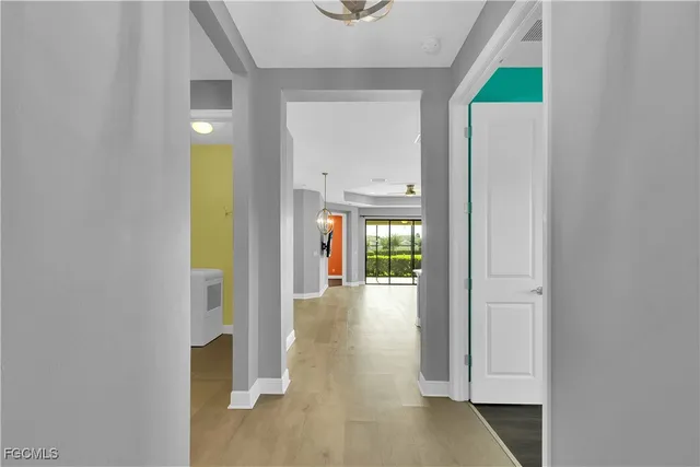 a view of a big room with wooden floor and windows