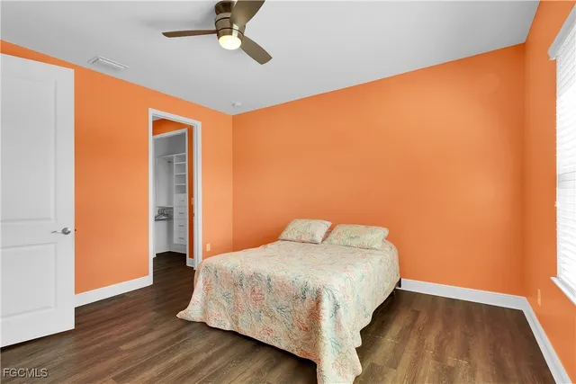 a view of a big room with wooden floor and windows