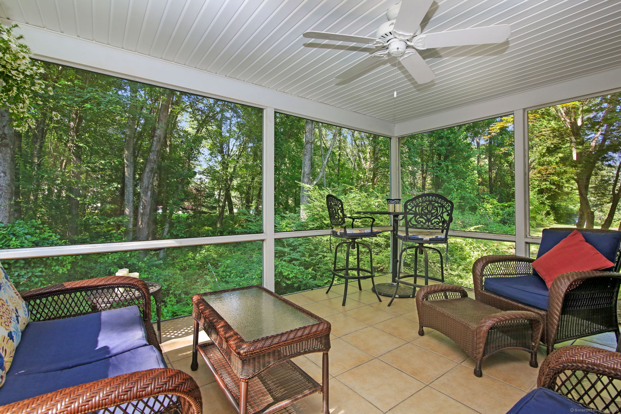 63 Pipers Hill Road Wilton, CT 06897 - Photo 15 of 37 a balcony with furniture and a yard