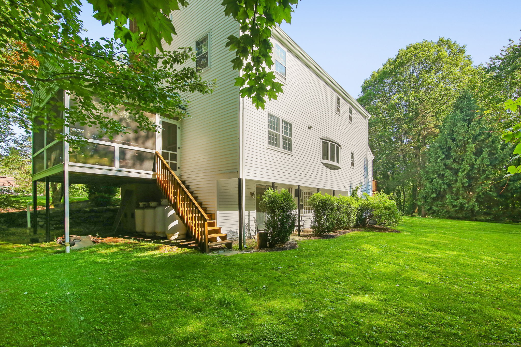 63 Pipers Hill Road Wilton, CT 06897 - Photo 16 of 37 a view of a house with backyard and a tree