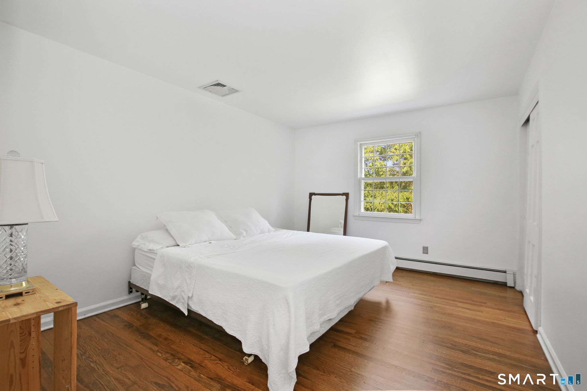 63 Pipers Hill Road Wilton, CT 06897 - Photo 23 of 37 a bedroom with a bed and a window